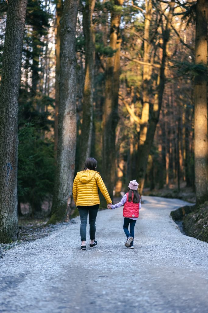 Mom walking with her daughter, practicing motherhood and self care. 